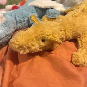 Jellycat Yellow Plush Dragon with Shimmery Gold Wings and Pink Flower Accents